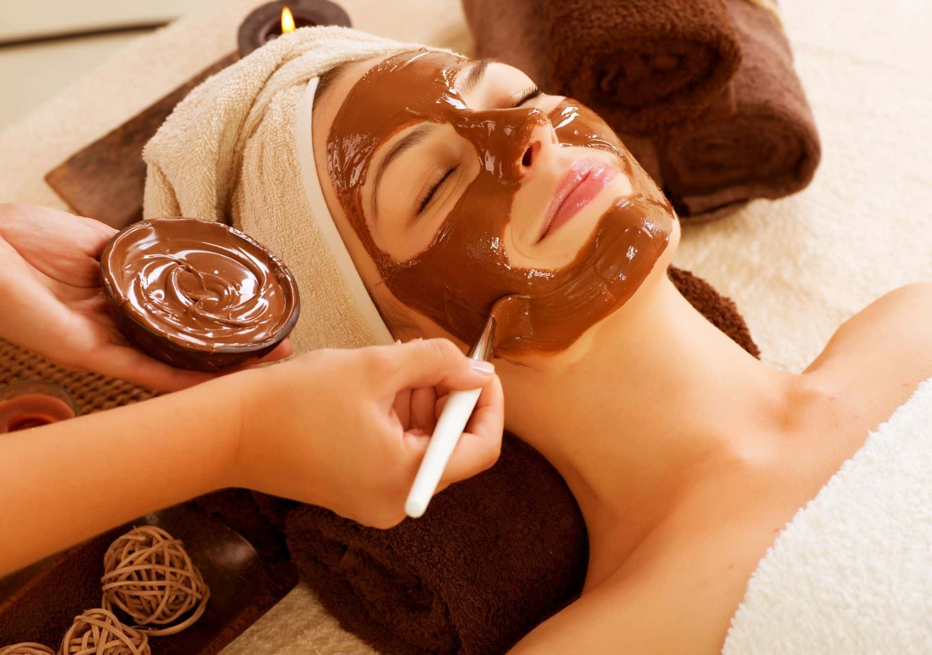 a woman getting a chocolate facial at a spa