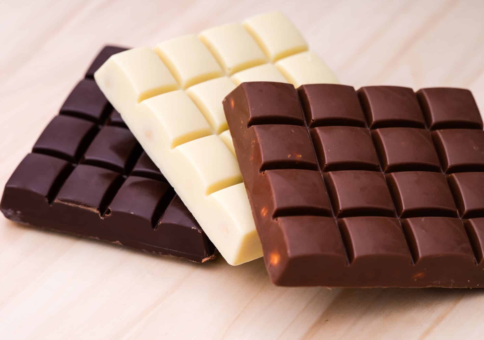 bars of dark, white, and milk chocolate on a table
