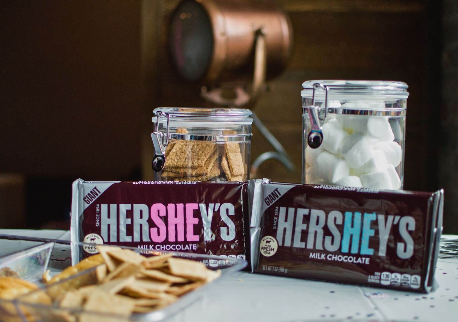 hersheys chocolate bars with graham crackers and marshmallows with light equipment in background 