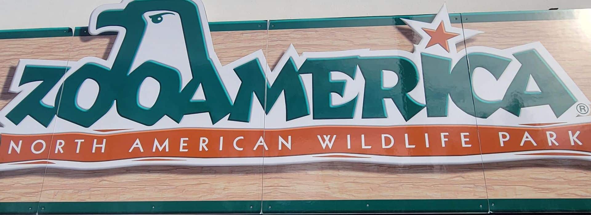 Zoo America, North American Wildlife Park sign in green lettering with the head of a bird depicted.