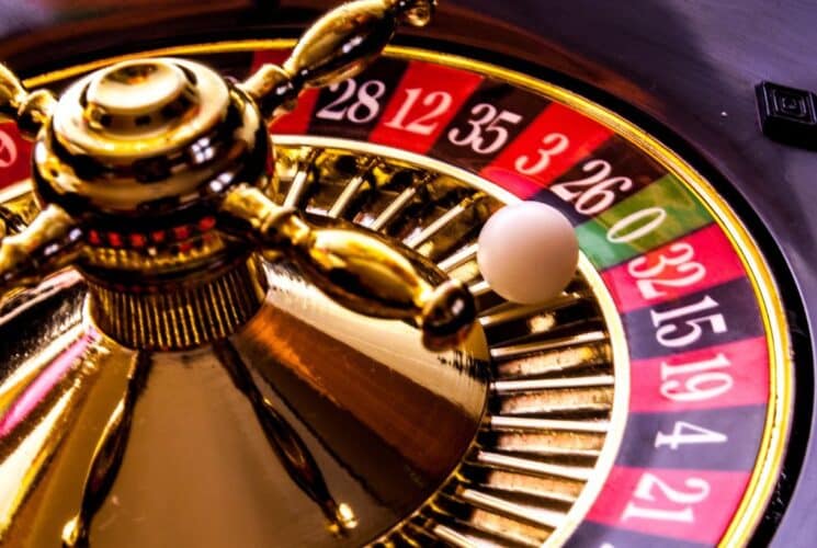 Up close view of a white ball rolling on a roulette table