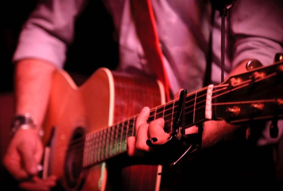 A man playing an acoustic guitar