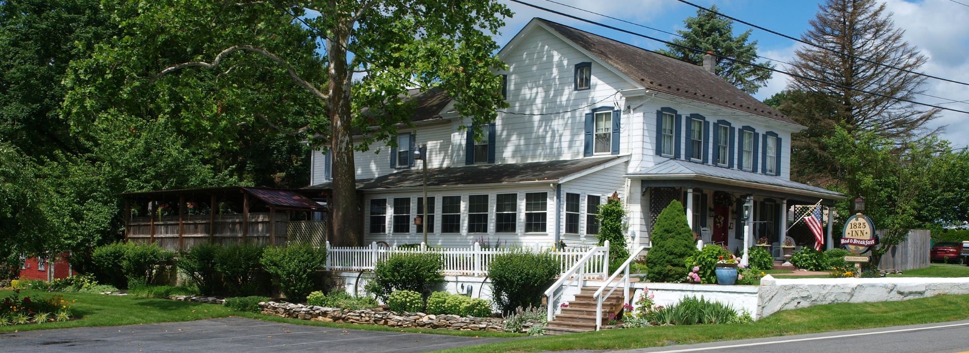 White farm house with front covered deck